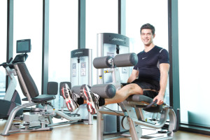 man exercising on leg extension machine